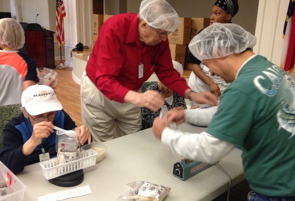 Chet Baker weighing meals at Glenaire Stop Hunger Now event