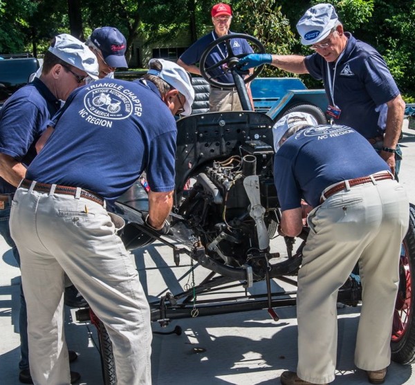 A team assembles a Model T 