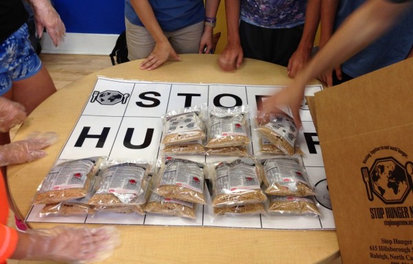 Stop Hunger Now uses a simple system of stations so that volunteers can package thousands of meals easily