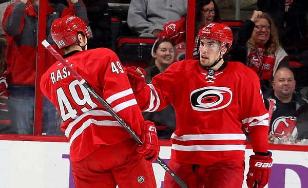 Justin Faulk of the Carolina Hurricanes celebrates his second-period goal with teammate Victor Rask.