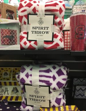 Fun fuzzy throws for all the local colleges are carried at Pink Alli in Stone Creek Village